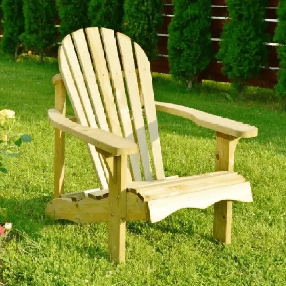 Pressure treated wooden Adirondack chair with natural light wood finish, vertical slat back design and wide armrests, positioned on green lawn with evergreen trees and garden shrubs in background