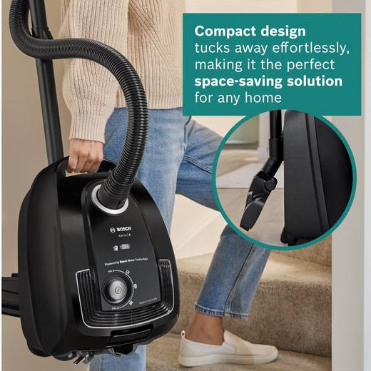 Person holding a compact vacuum cleaner with text highlighting its space-saving design.