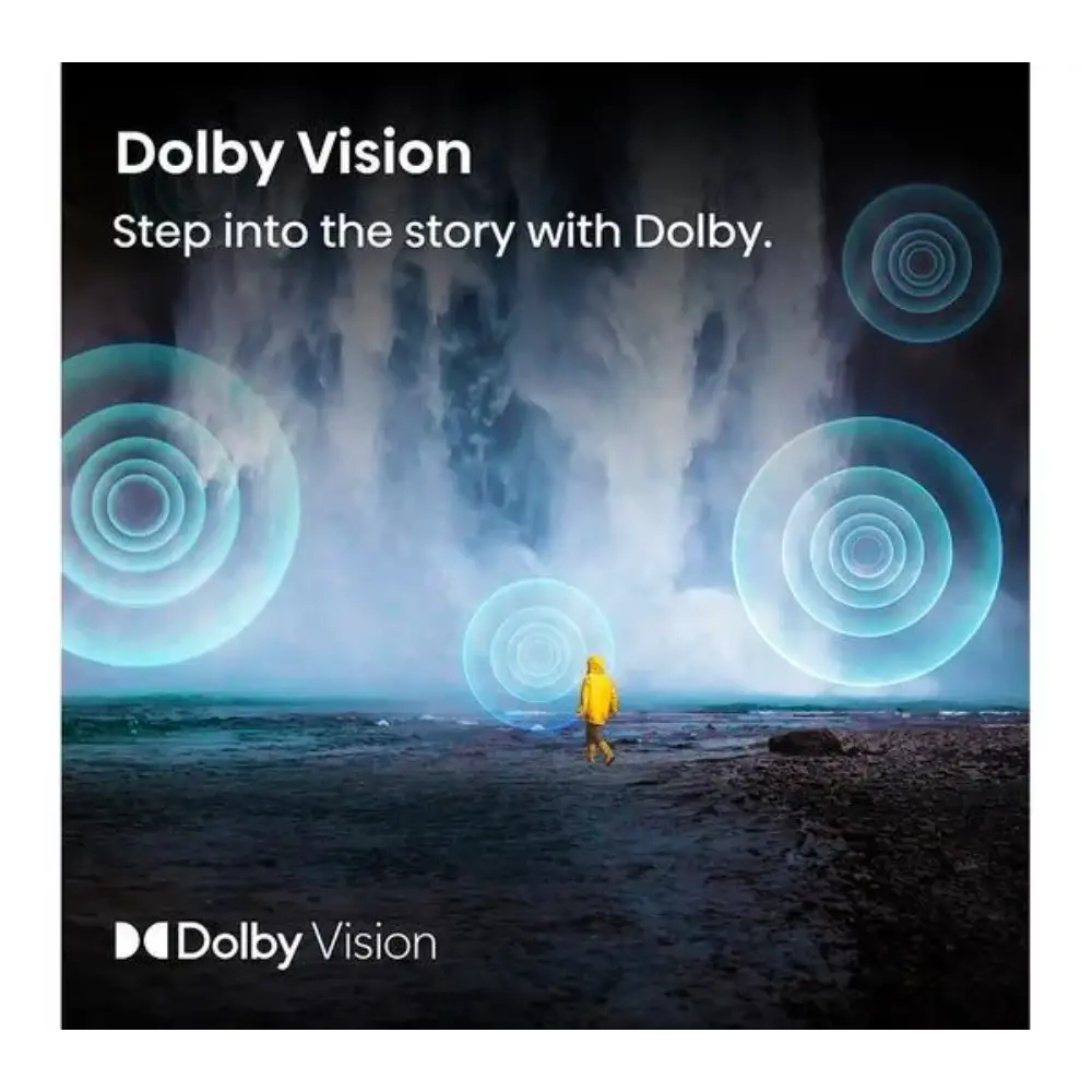 Dolby Vision promotional advertisement featuring a person in a yellow jacket standing on a beach facing the ocean with glowing turquoise circular sound wave patterns overlaid in the sky, with "Step into the story with Dolby" tagline and Dolby Vision branding