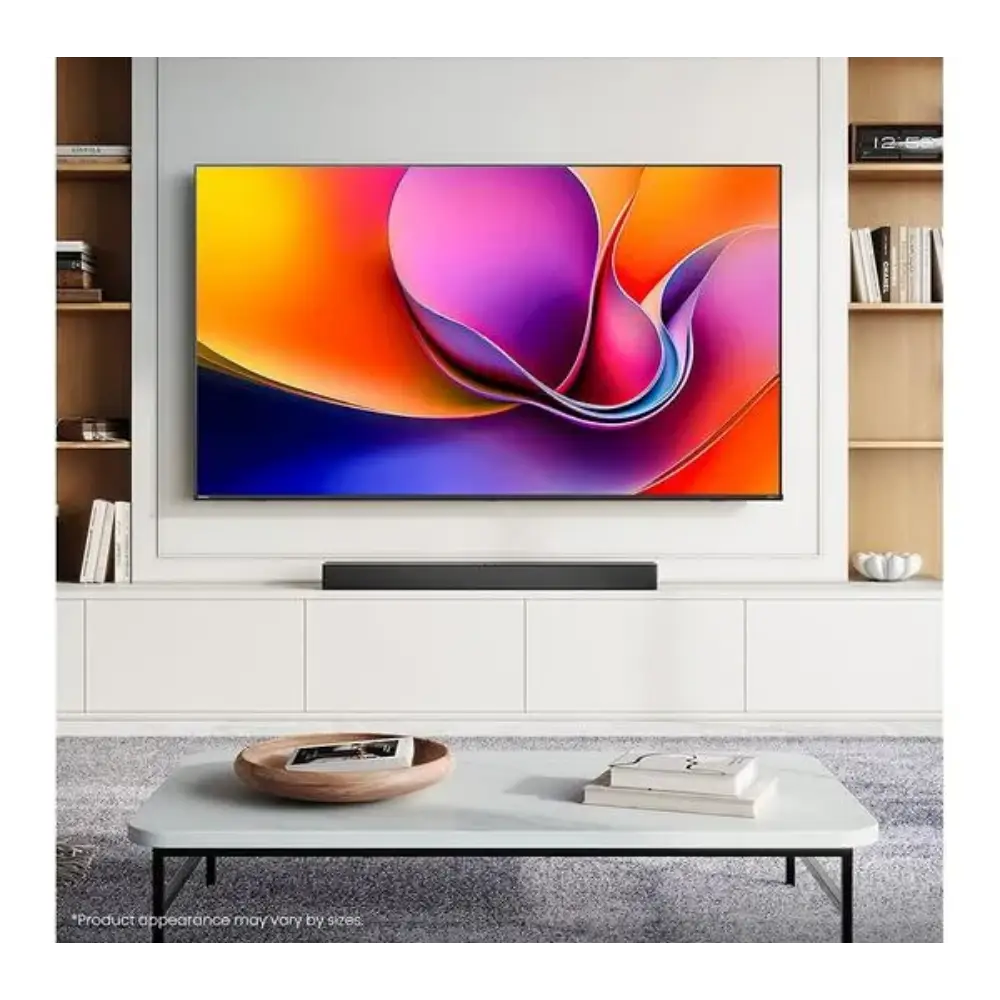 Hisense A6Q 65 inch 4K Smart TV mounted on white wall unit with wooden shelving displaying vibrant colorful abstract wallpaper on screen, black soundbar below, white coffee table with wooden bowl and books in modern living room setting