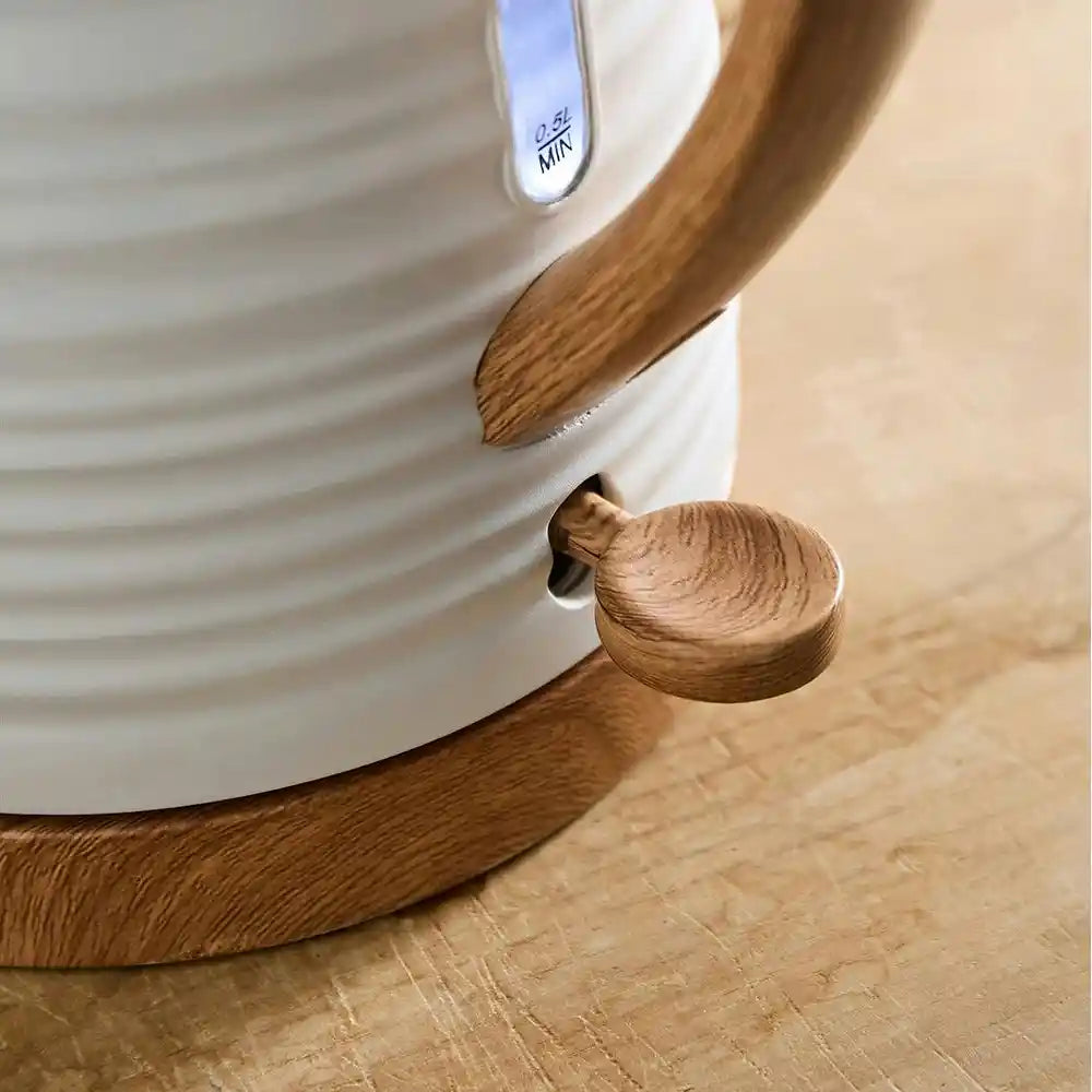 White ceramic jug kettle with wooden handle and knob detail on beige wooden surface, showing Morphy Richards branding