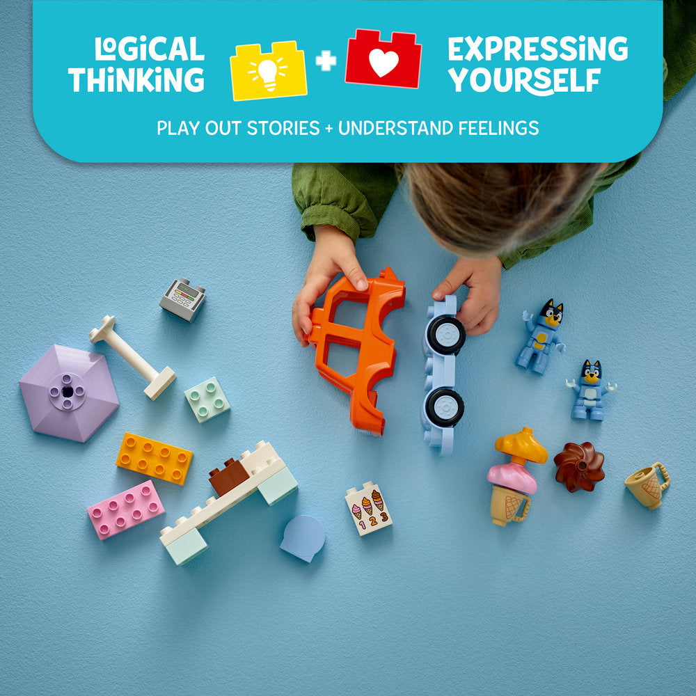 Child's hands assembling colorful LEGO bricks including orange connectors, pink and yellow building blocks, blue minifigures of Bluey characters, ice cream elements, and a white vehicle with black wheels on a turquoise background, with messaging about logical thinking and expressing yourself through play