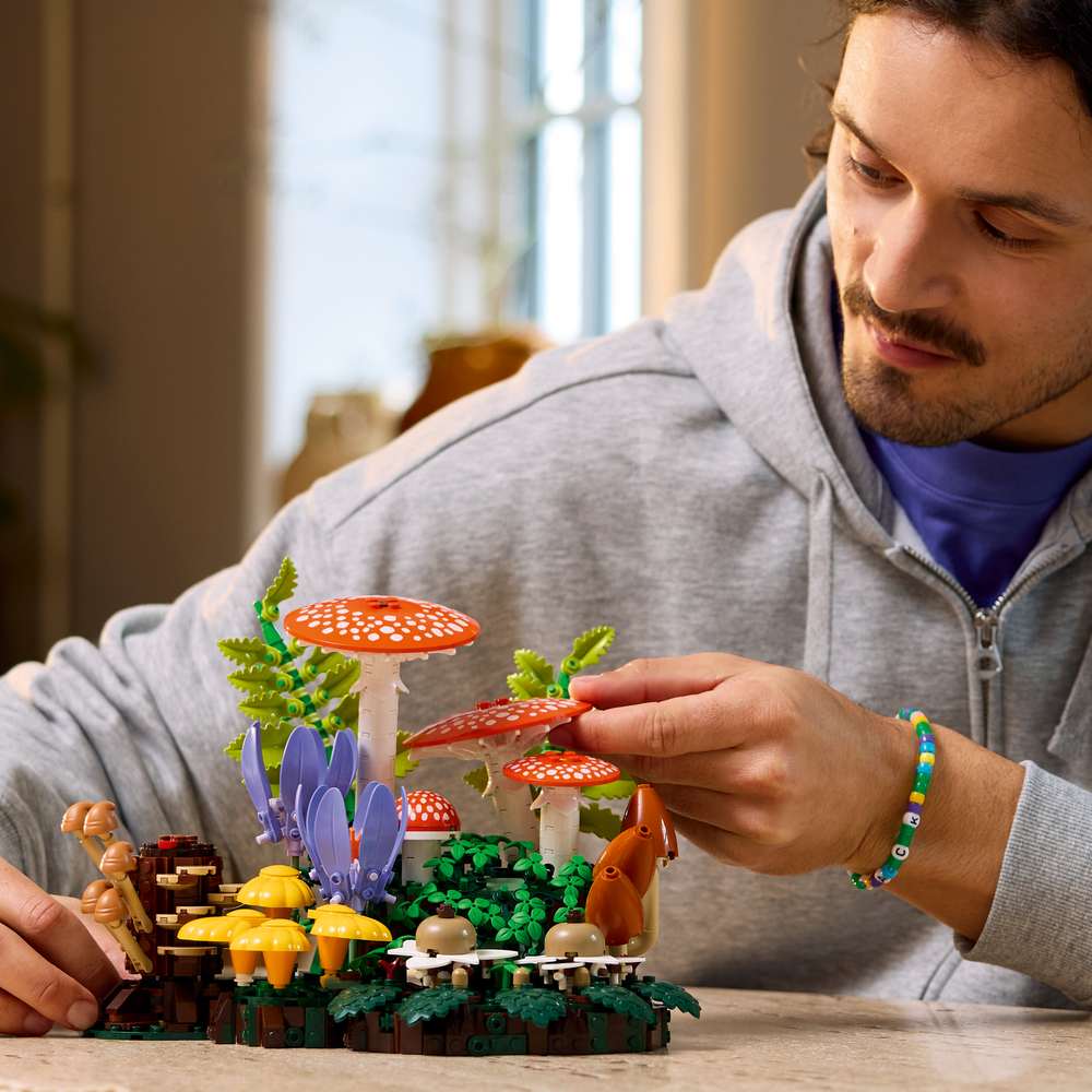LEGO Botanicals Woodland Mushrooms 11505 - a child playing with the finished build. 806 pieces. Ages 18+.