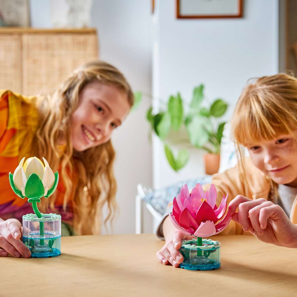 LEGO Botanicals Water Lilies 11511 - a child playing with the finished build. 259 pieces. Ages 9+.