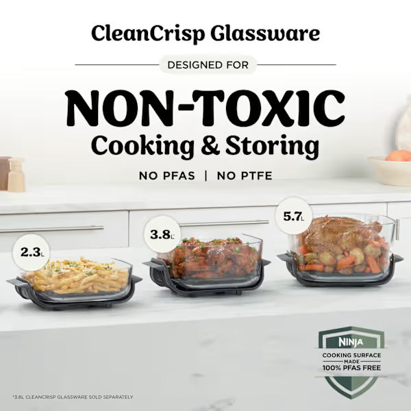CleanCrisp Glassware product display showing three non-toxic glass cooking and storage containers in black frames with capacities of 2.3, 3.8, and 5.7 liters, filled with prepared food dishes, featuring PFAS and PTFE-free Ninja cooking surface branding
