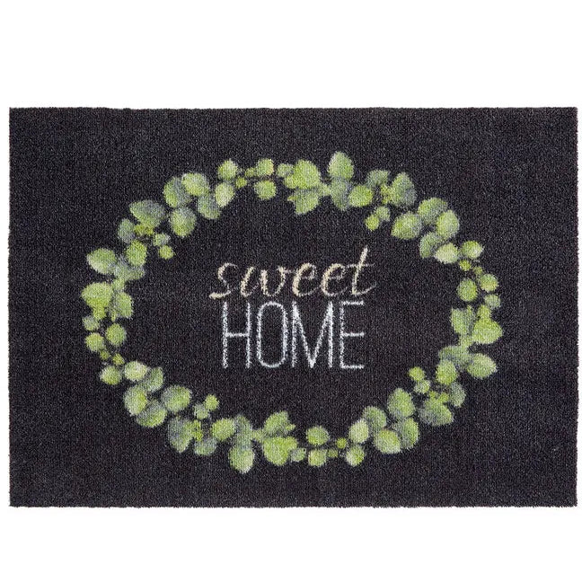 Dark grey coir doormat with eucalyptus leaf wreath design in soft green and white text reading sweet home, 50cm x 70cm size