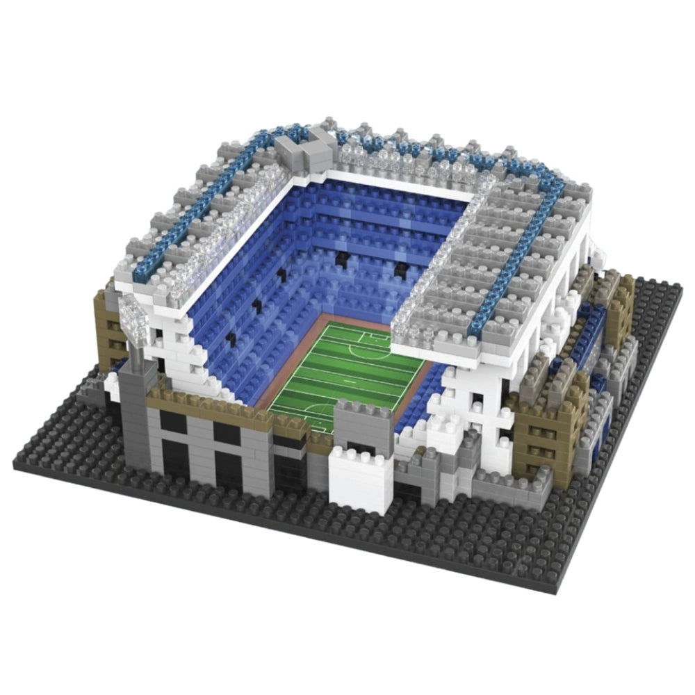 Model of a stadium made from interlocking bricks on a white background