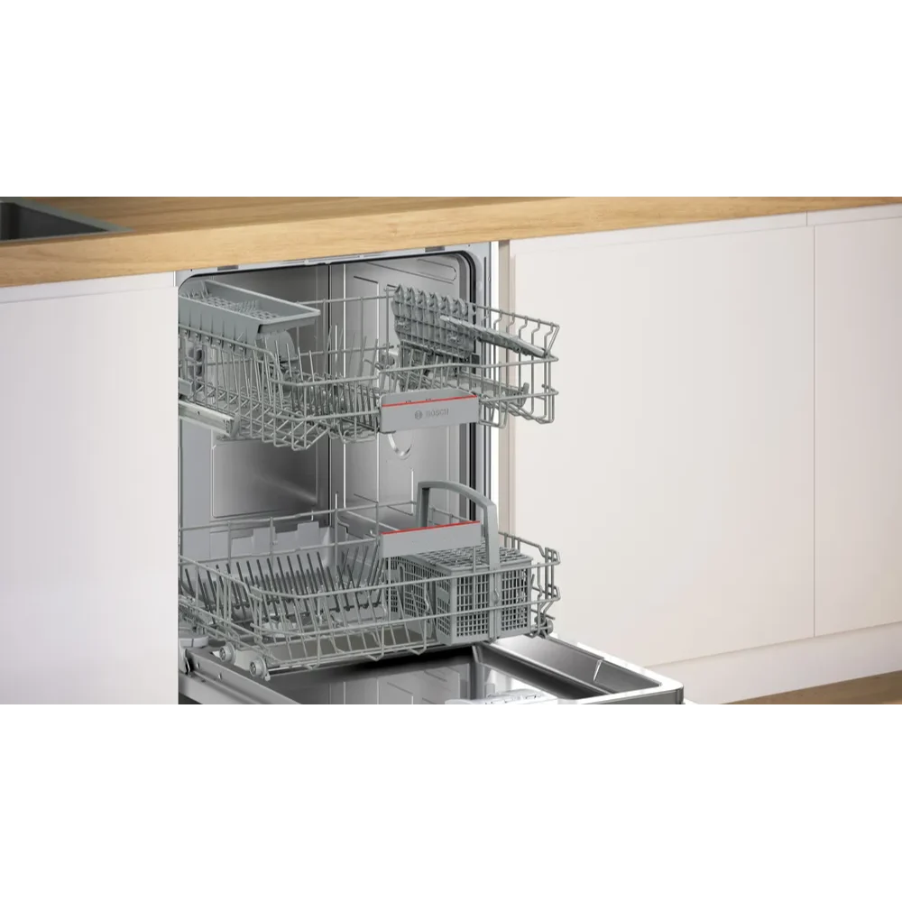 Bosch Serie 4 integrated dishwasher with stainless steel racks and white cabinet doors partially open showing upper and lower basket compartments in a modern kitchen setting with wooden countertop