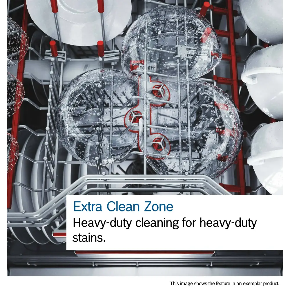Interior view of Bosch Series 6 dishwasher showing Extra Clean Zone feature with two spray arms actively cleaning heavily soiled plates, demonstrating heavy-duty water jets and red mechanical components against stainless steel drum