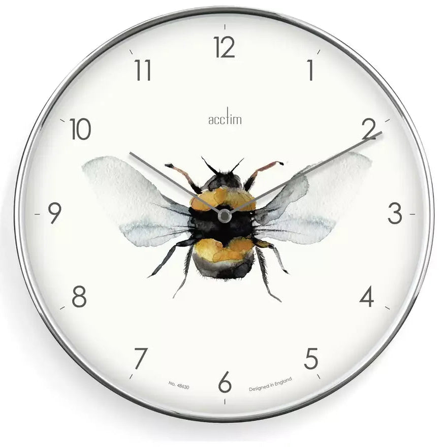 Acctim Society Bee analogue wall clock with silver frame featuring a watercolor illustration of a bumblebee with yellow and black stripes and translucent wings at the center, surrounded by numbered dial markers 1-12 on a cream face