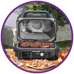 Portable grill with food on a table outdoors