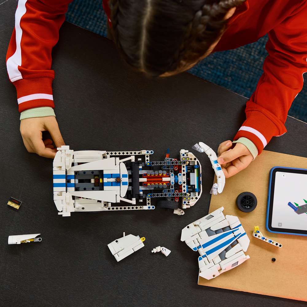 LEGO Technic Dodge Viper GTS-R Sports Car 42234 - a child building the set. 805 pieces. Ages 10+.