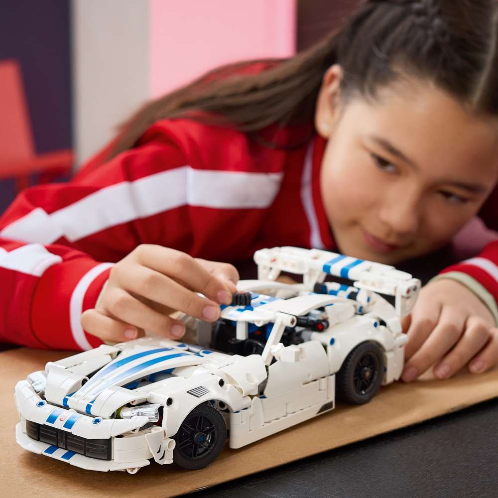 LEGO Technic Dodge Viper GTS-R Sports Car 42234 - a child playing with the finished build. 805 pieces. Ages 10+.