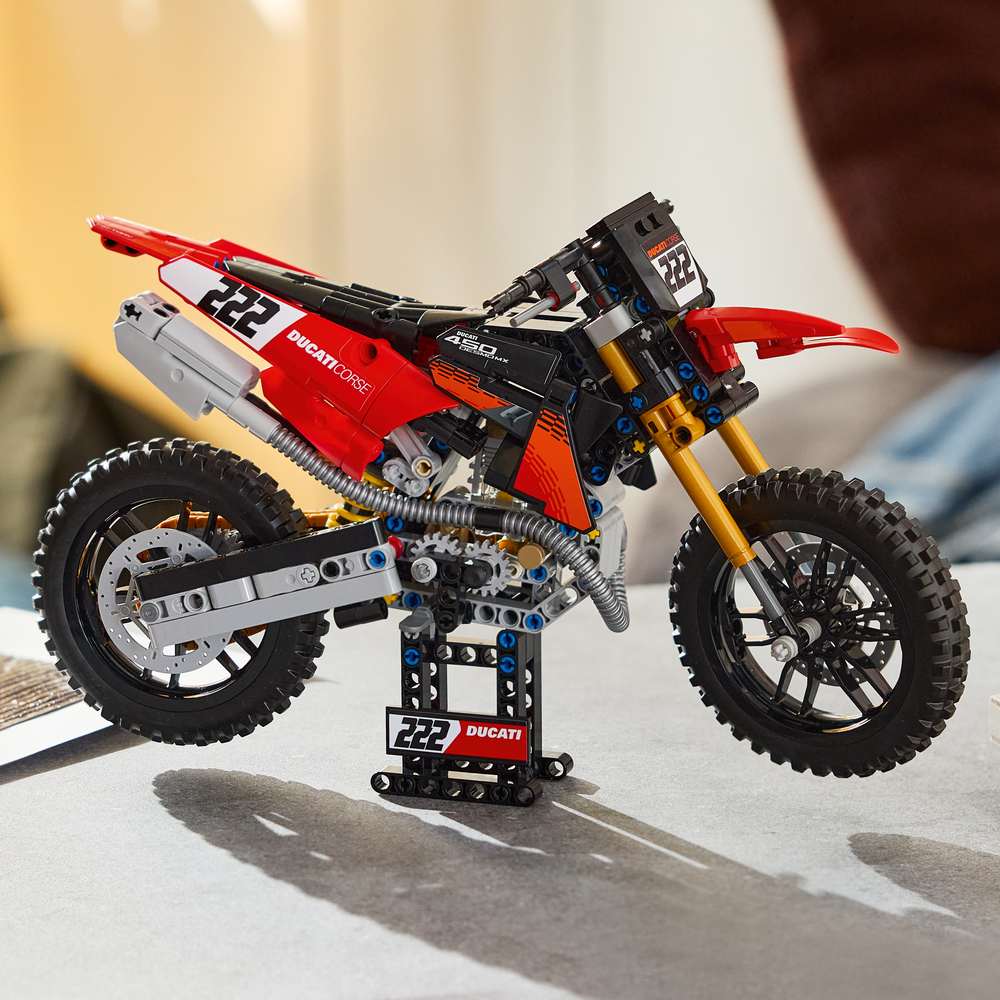 LEGO Technic Ducati Desmo450 MX Factory Motorcycle 42238 - the finished build shown in a home setting. 457 pieces. Ages 10+.