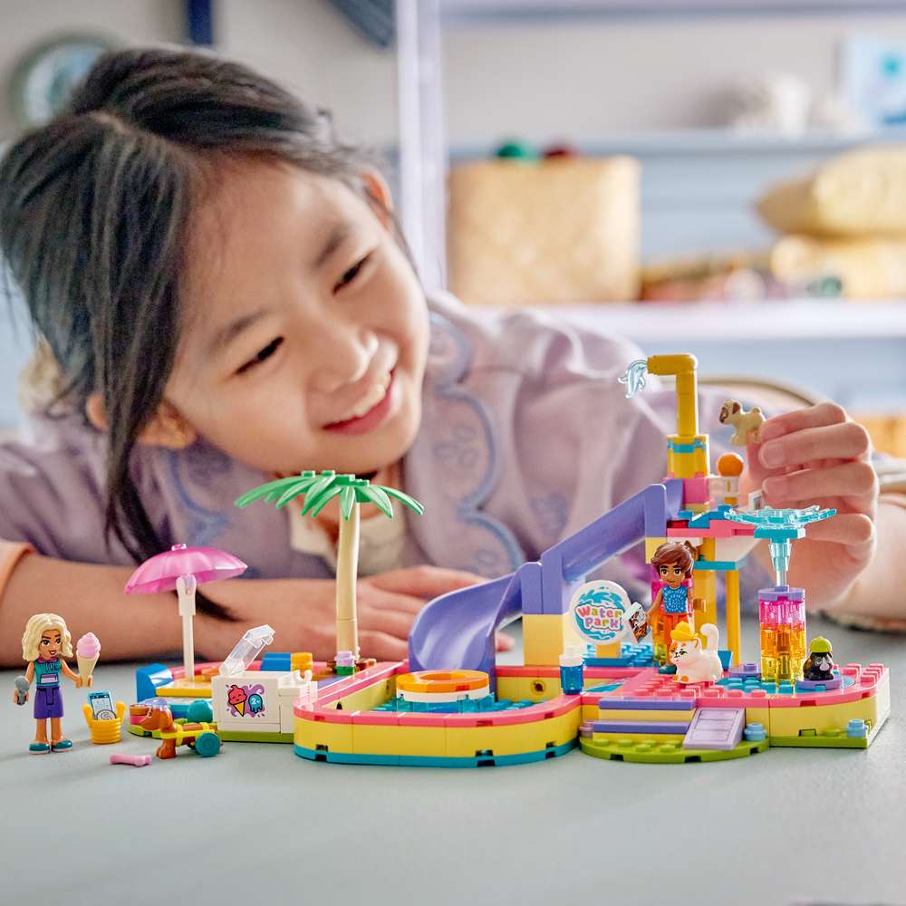 LEGO Friends Fun Water Park Day 42676 - a child playing with the finished build. 278 pieces. Ages 6+.