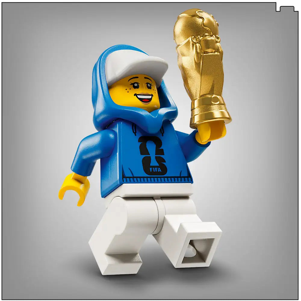 LEGO FIFA World Cup minifigure in blue and white sports outfit holding golden trophy replica, official set 43020