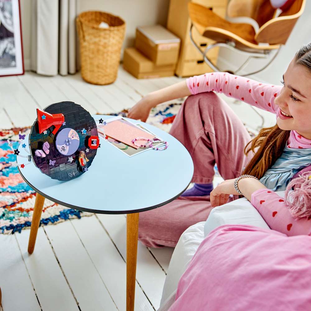 LEGO Editions Music Olivia Rodrigo's Vinyl 43028 - a child playing with the finished build. 360 pieces. Ages 10+.