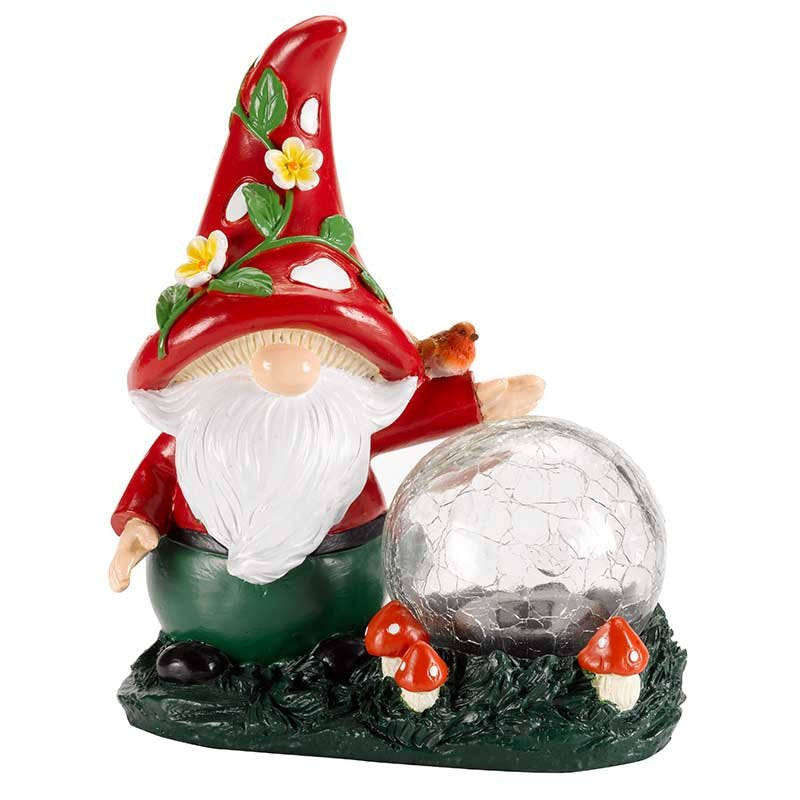 Garden gnome solar light with red pointed hat decorated with yellow flowers, white beard, red jacket, green trousers, holding a silver crackle glass orb, standing on green base with red and white mushrooms