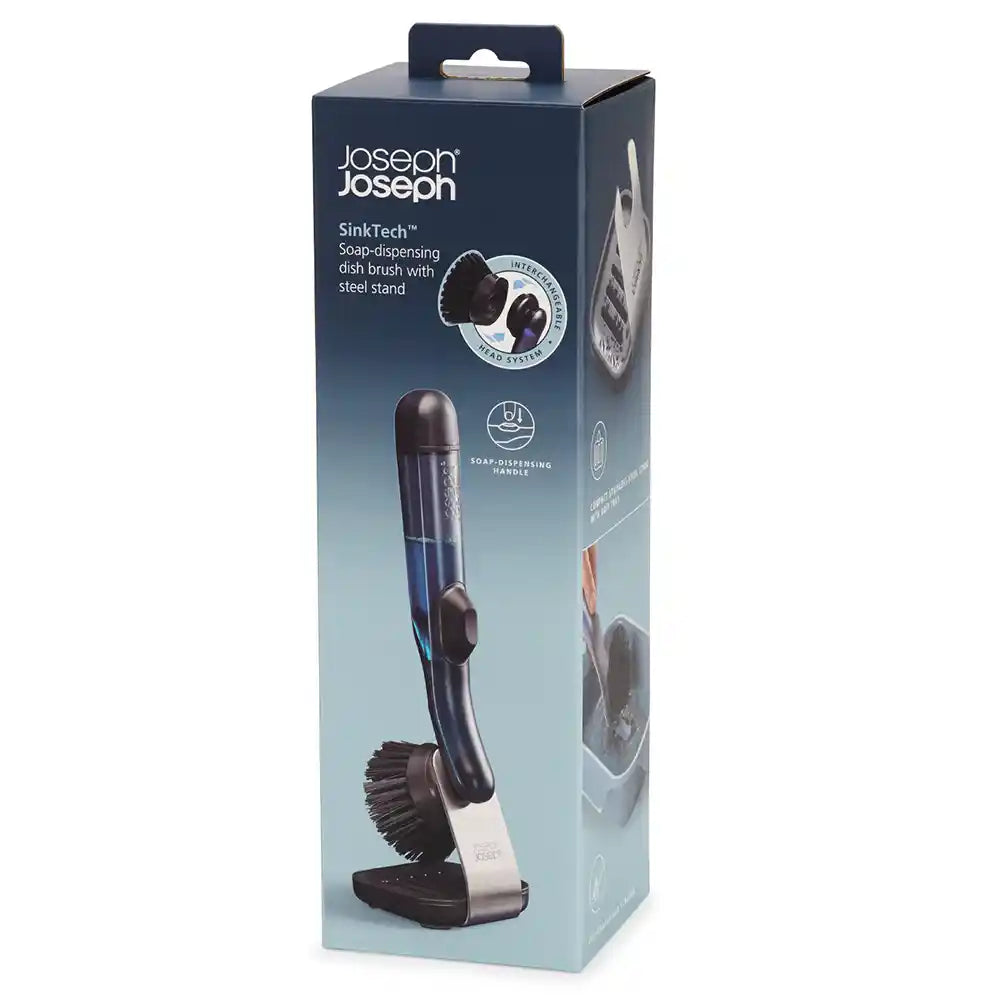 Joseph Joseph SinkTech soap dispensing dish brush with steel stand in dark grey and white, displayed in packaging showing the integrated soap dispenser handle and brush head with stand base