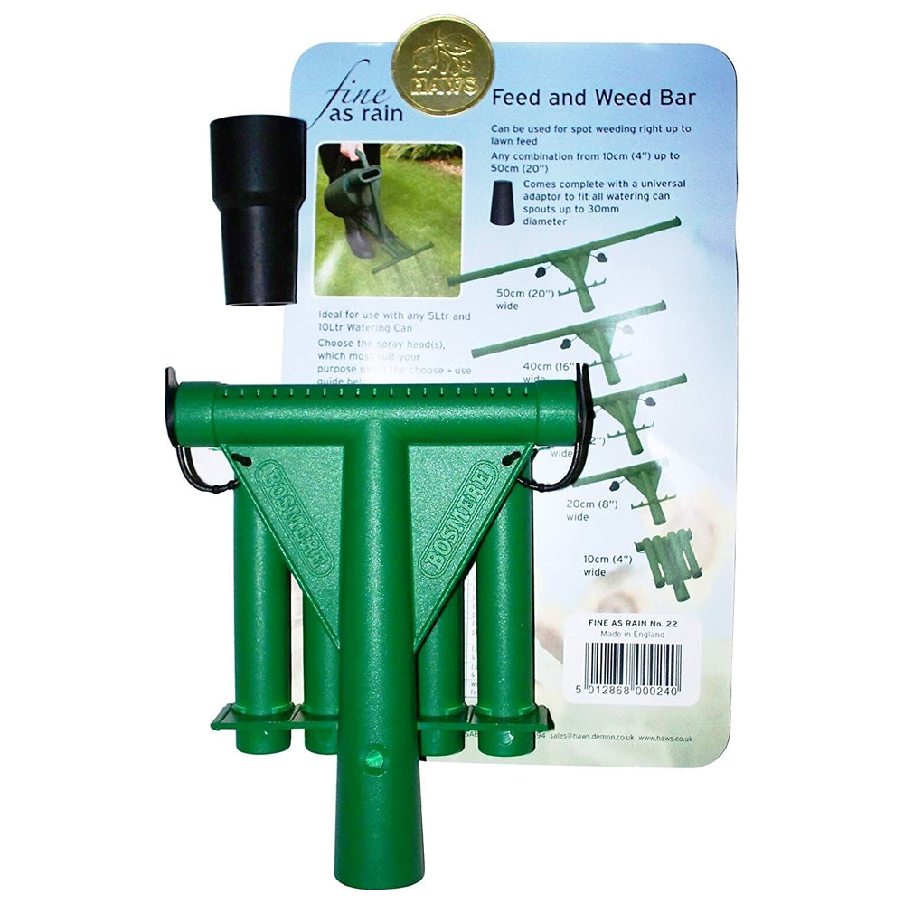 Green metal feed and weed bar attachment for watering can with black handles and universal adaptor, displayed with product packaging showing multiple width options from 10cm to 50cm