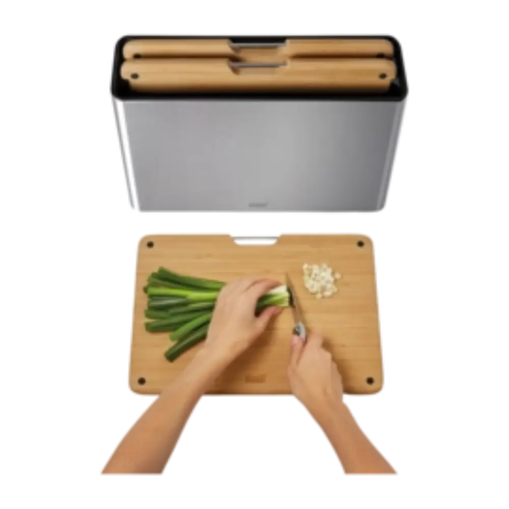 Joseph Joseph Folio Steel Bamboo three piece chopping board set showing grey steel and natural bamboo boards with hands chopping green beans on wooden board