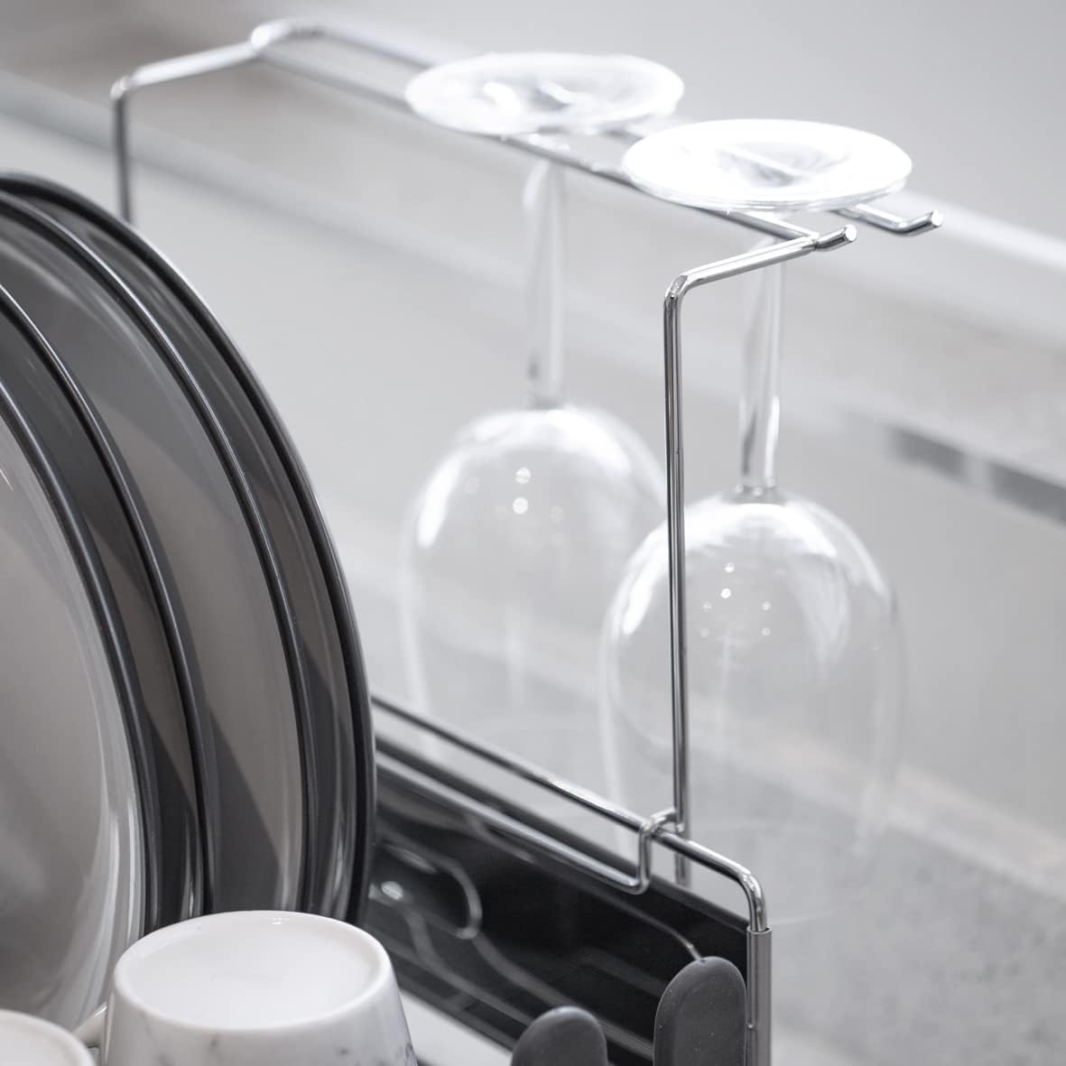 Blackmoor Deluxe Dish Drainer in black with chrome accents featuring clear glass wine glass holders and white plate storage compartment on modern kitchen counter