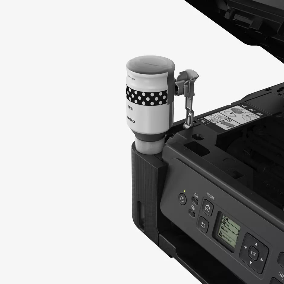 Coffee cup with polka dot sleeve being used with a printer on a white background