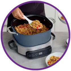 Person cooking food in a pot on a stove with a purple border.