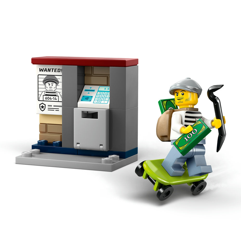LEGO Police Motorcycle Chase set 60455 featuring a yellow minifigure criminal on a lime green motorcycle with a pickaxe, a gray police station building with wanted poster and ATM, displayed against white background