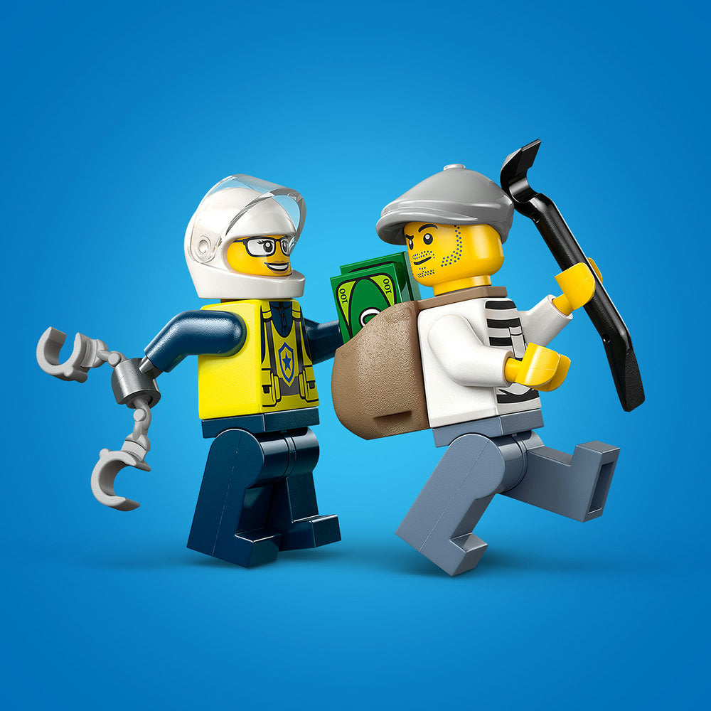 Two LEGO minifigures against a blue background: a police officer in white helmet and yellow jacket holding silver handcuffs on the left, and a thief in grey cap and white shirt holding a pickaxe and money bag on the right, from LEGO set 60455 Police Motorcycle Chase