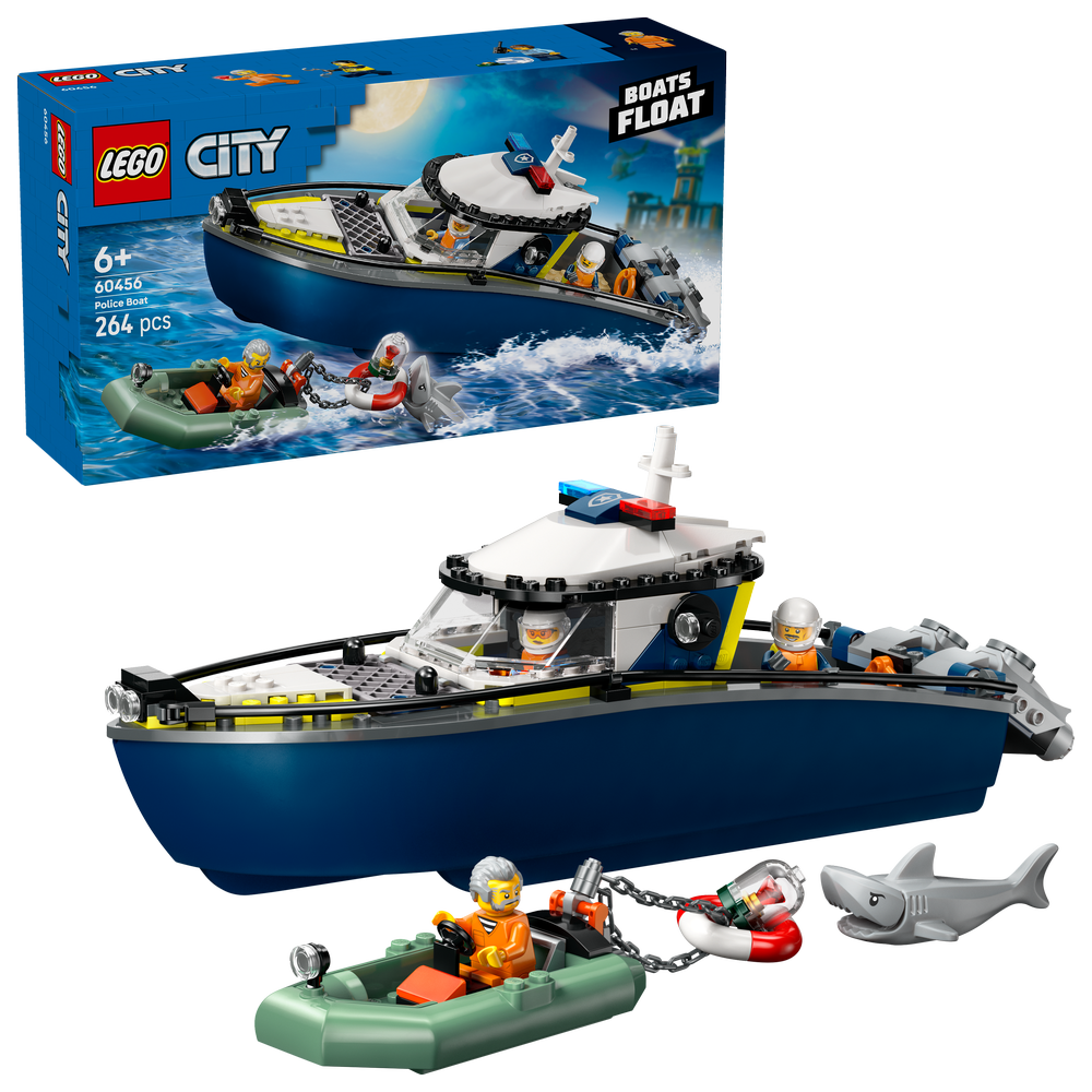 LEGO City Police Boat Chase set 60456 featuring a dark blue and yellow police boat with white cabin, minifigures, green inflatable rescue raft, shark figure, and product packaging against white background