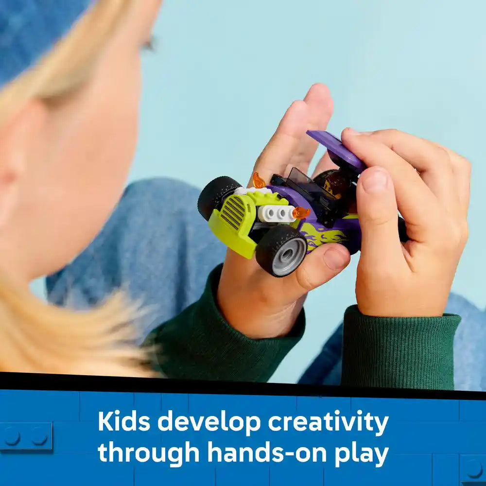 Child's hands holding a bright lime-green and black LEGO hot rod car with purple accents against a clear blue sky, demonstrating creative hands-on play with building blocks