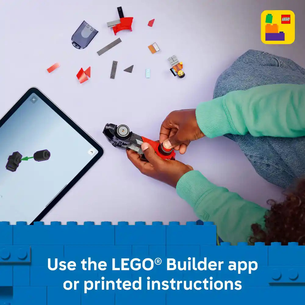 Child in green sleeves assembling red and black LEGO EV Supercar model with scattered bricks and tablet showing LEGO Builder app instructions, blue baseplate visible below