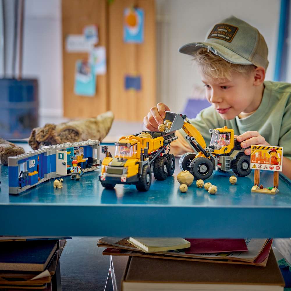 LEGO City Dump Truck & Front End Loader 60494 - a child playing with the finished build. 1132 pieces. Ages 8+.