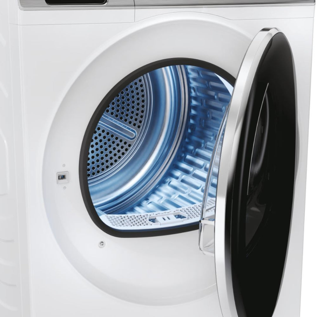 White Haier I-Pro Series 7 Plus heat pump tumble dryer with open door showing blue drum interior and perforated metal surfaces against white background