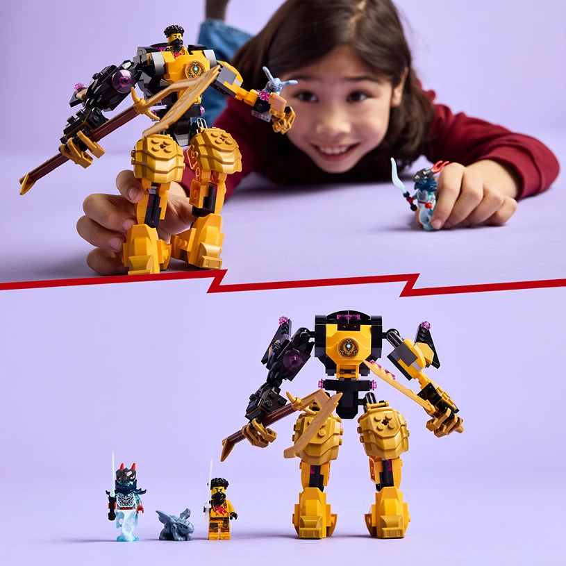 Child holding yellow and black LEGO Spinjitzu Battle Mech with articulated limbs and purple accents, displayed above a scale comparison showing the mech with three smaller LEGO minifigures and components against a purple background