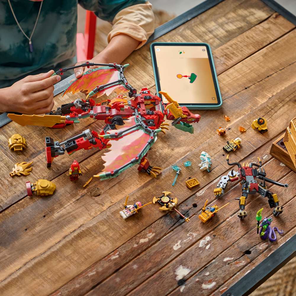 LEGO Ninjago Wyldfyre's Transforming Dragon Mech 71868 - a child building the set. 821 pieces. Ages 9+.