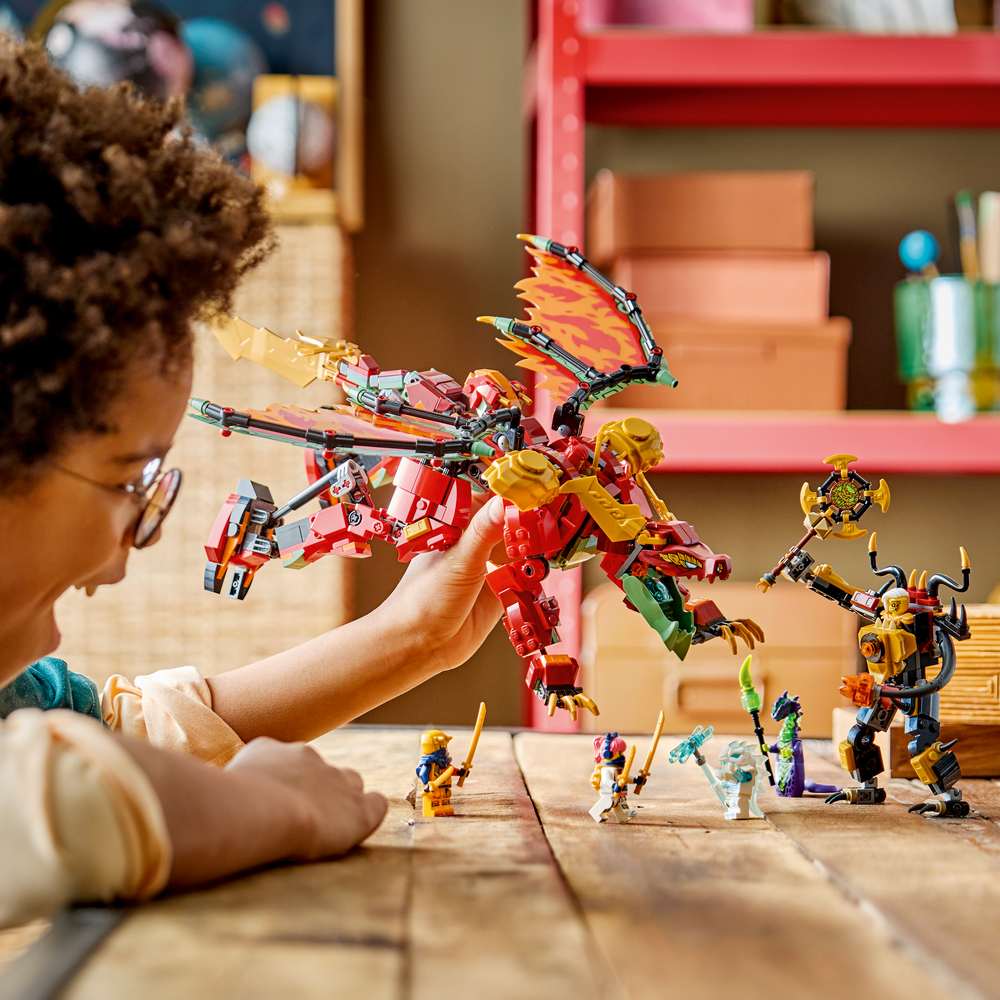 LEGO Ninjago Wyldfyre's Transforming Dragon Mech 71868 - a child playing with the finished build. 821 pieces. Ages 9+.