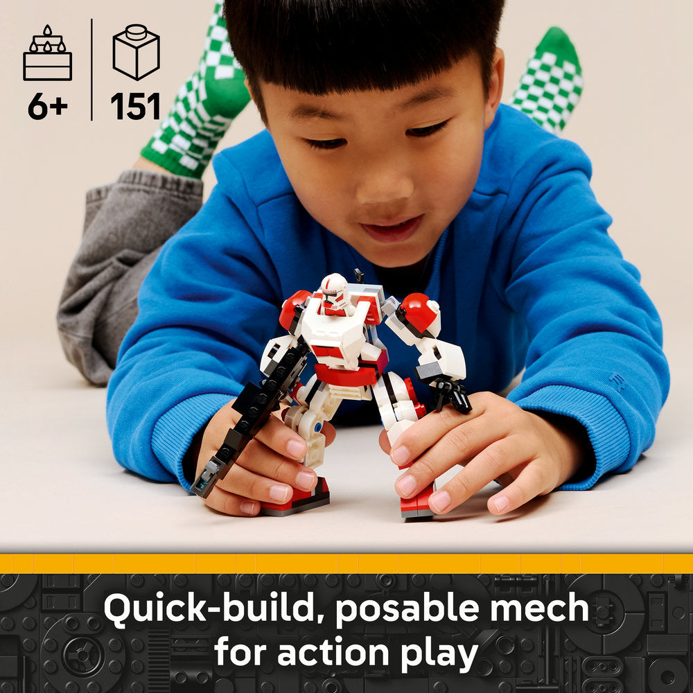 Young child in blue hoodie playing with red, white and black LEGO mech robot figure, demonstrating posable action features, with green checkered party hat visible in background, 151 piece buildable set for ages 6+