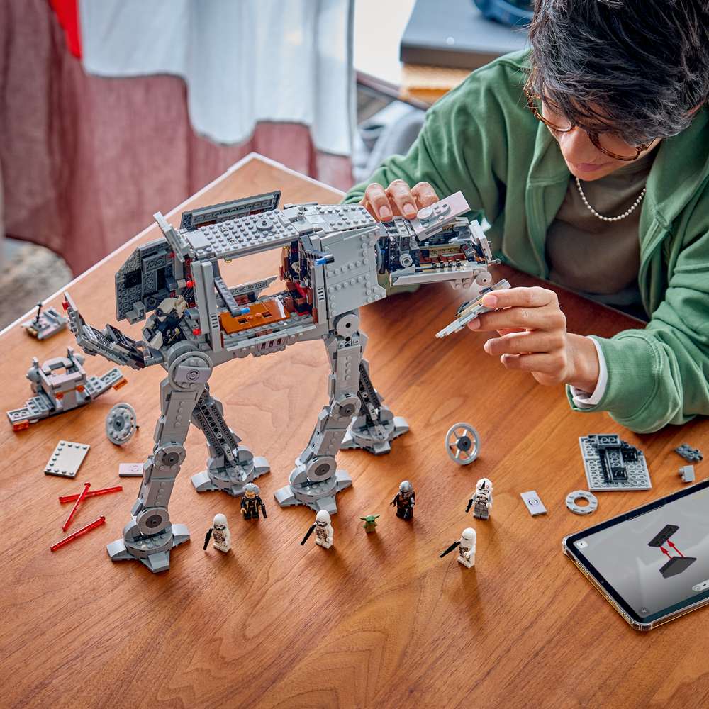 LEGO Star Wars™ Imperial Remnant AT-AT™ with INT-4 75454 - a child building the set. 1453 pieces. Ages 10+.