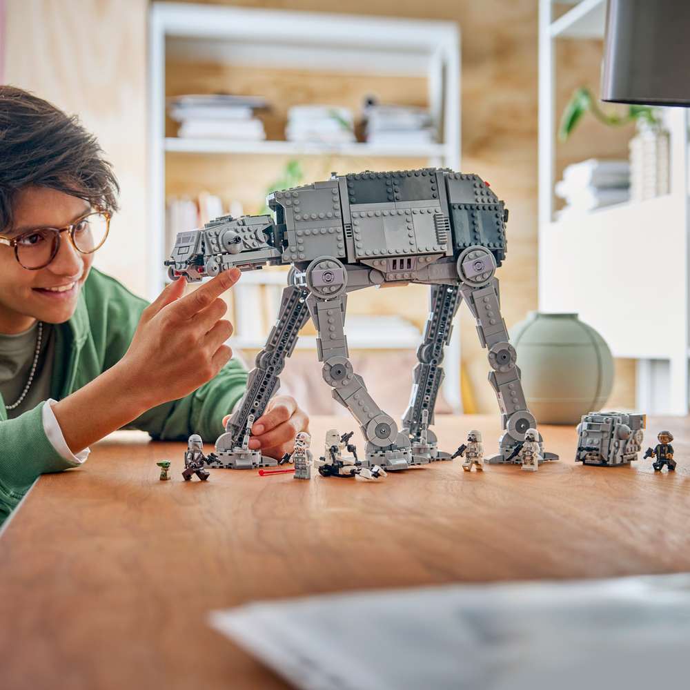 LEGO Star Wars™ Imperial Remnant AT-AT™ with INT-4 75454 - a child playing with the finished build. 1453 pieces. Ages 10+.