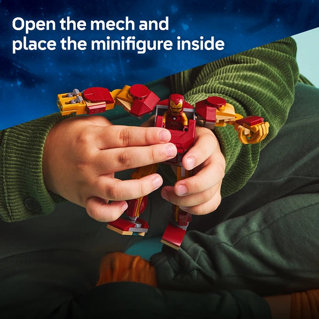 Child's hands holding a red and gold LEGO Iron Man mech suit with yellow and red component pieces displayed above, wearing a green knitted sweater, product instruction text visible at top