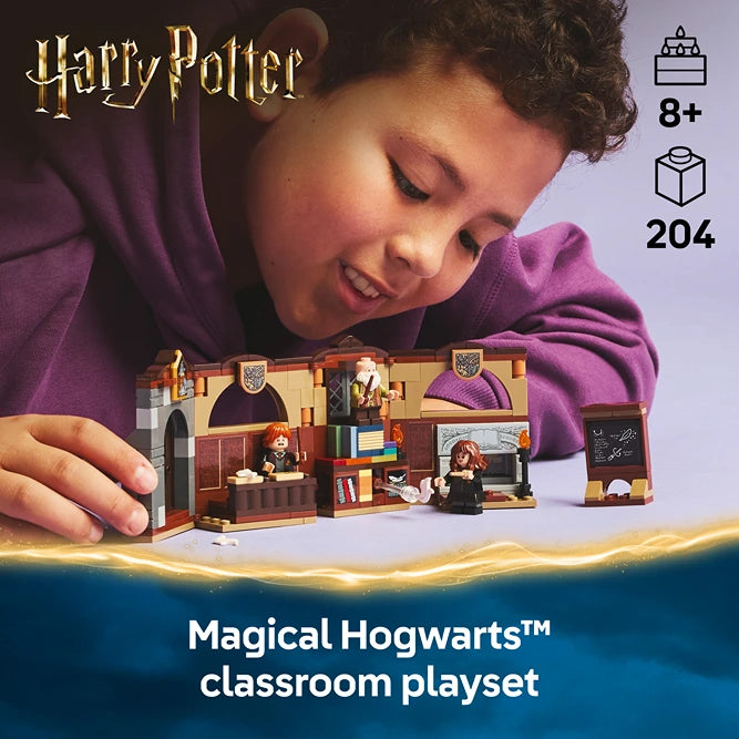 Child playing with LEGO Harry Potter Magical Hogwarts classroom playset 76442 featuring brown and gold modular classroom building with minifigures, displaying 204 pieces, age 8+, against blue and gold gradient background