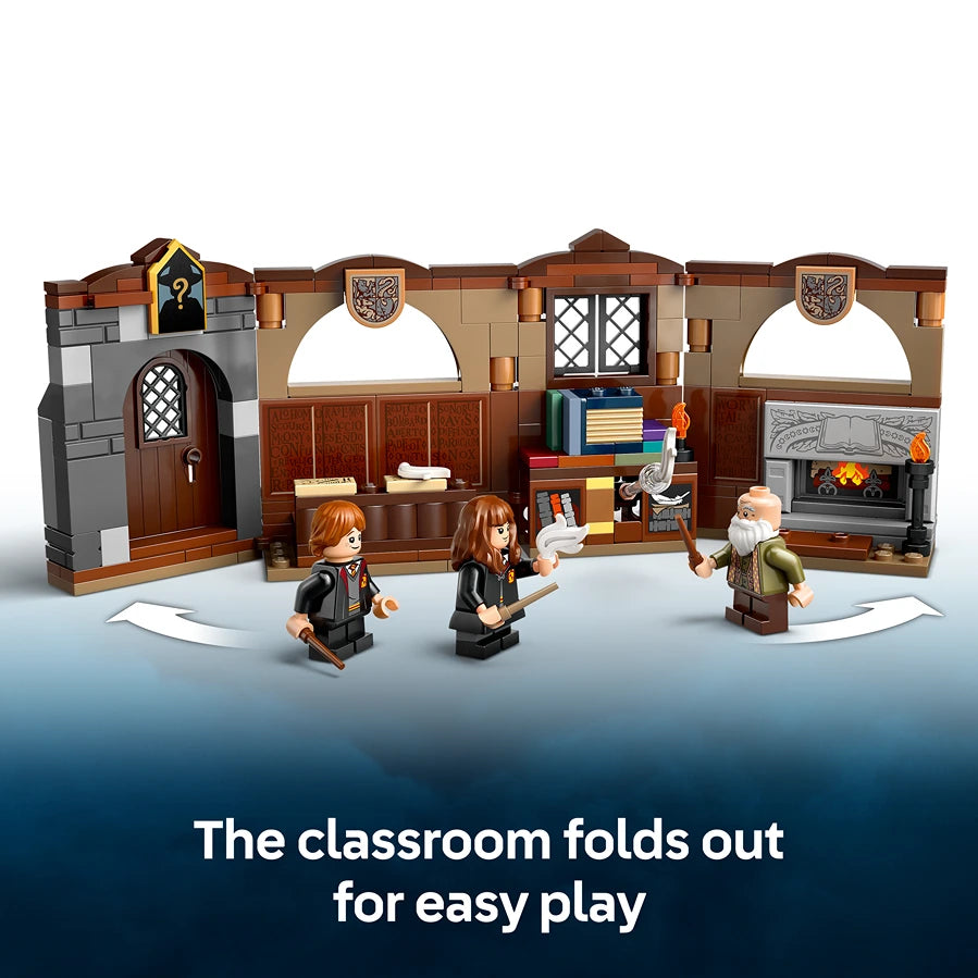 LEGO Hogwarts Castle Charms Class 76442 playset showing a brown and grey stone castle classroom structure with wooden doors and arched windows, featuring three minifigures in black wizard robes and an elderly wizard character, with the text "The classroom folds out for easy play" displayed below
