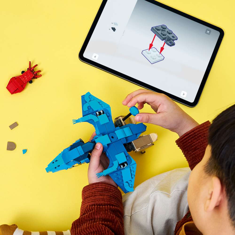 LEGO Jurassic World Baby Dinosaur: Pteranodon 77977 - a child building the set. 373 pieces. Ages 7+.