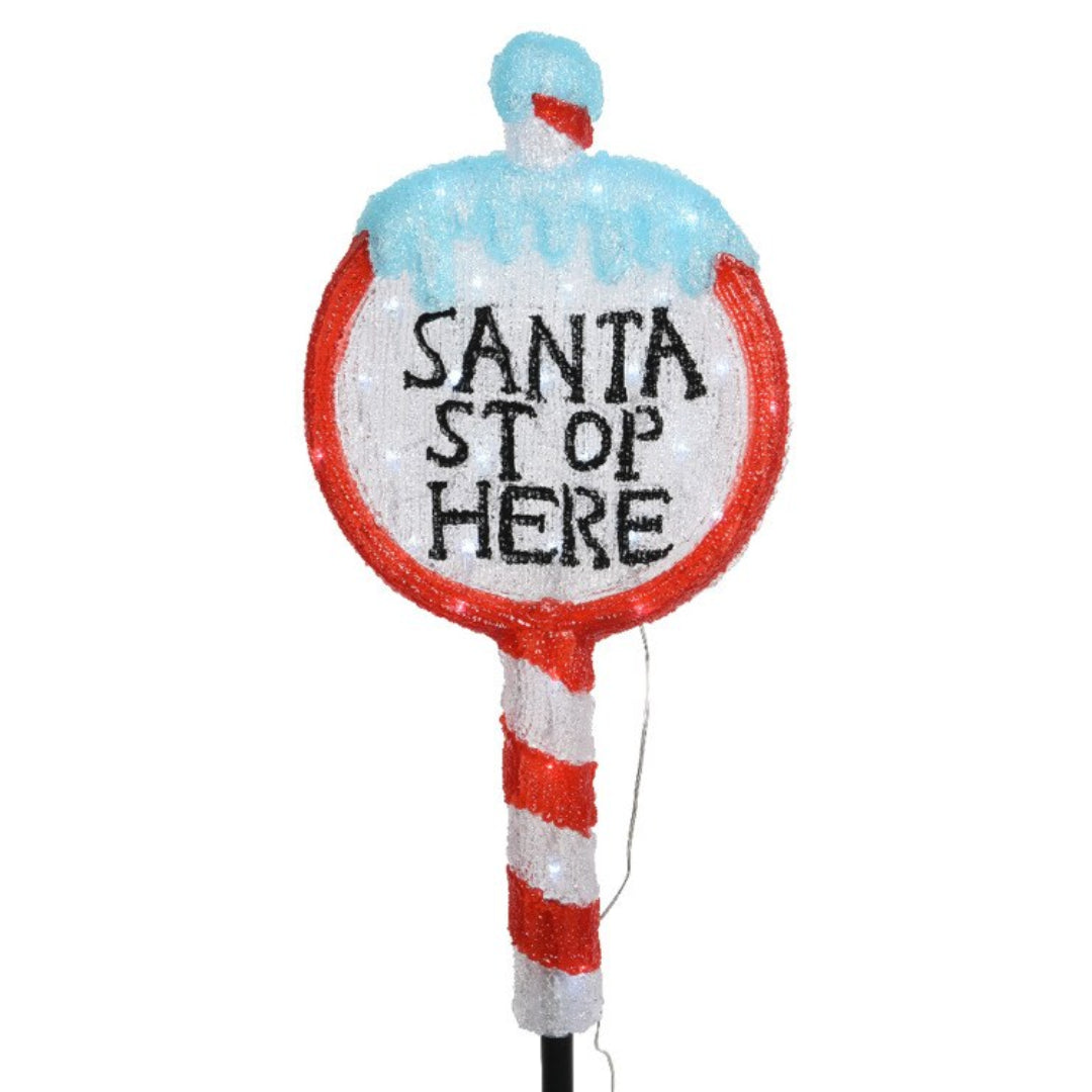 Kaemingk Lumineo 30 LED Christmas Santa Stop Here Sign Light, 67cm tall decorative outdoor display featuring red and white striped candy cane pole with light blue Santa hat top and white circular sign with black text, glittering finish with warm white LED lights