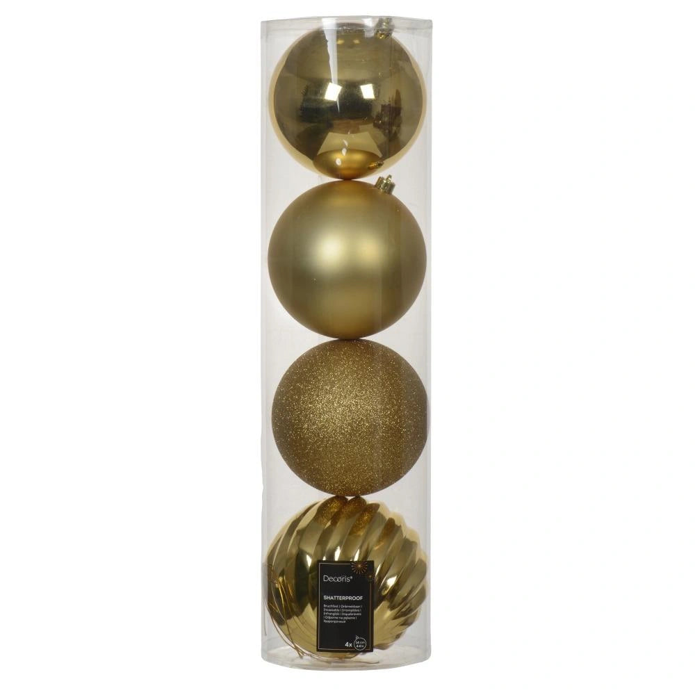 Set of gold Christmas ornaments in a clear cylindrical packaging on a white background