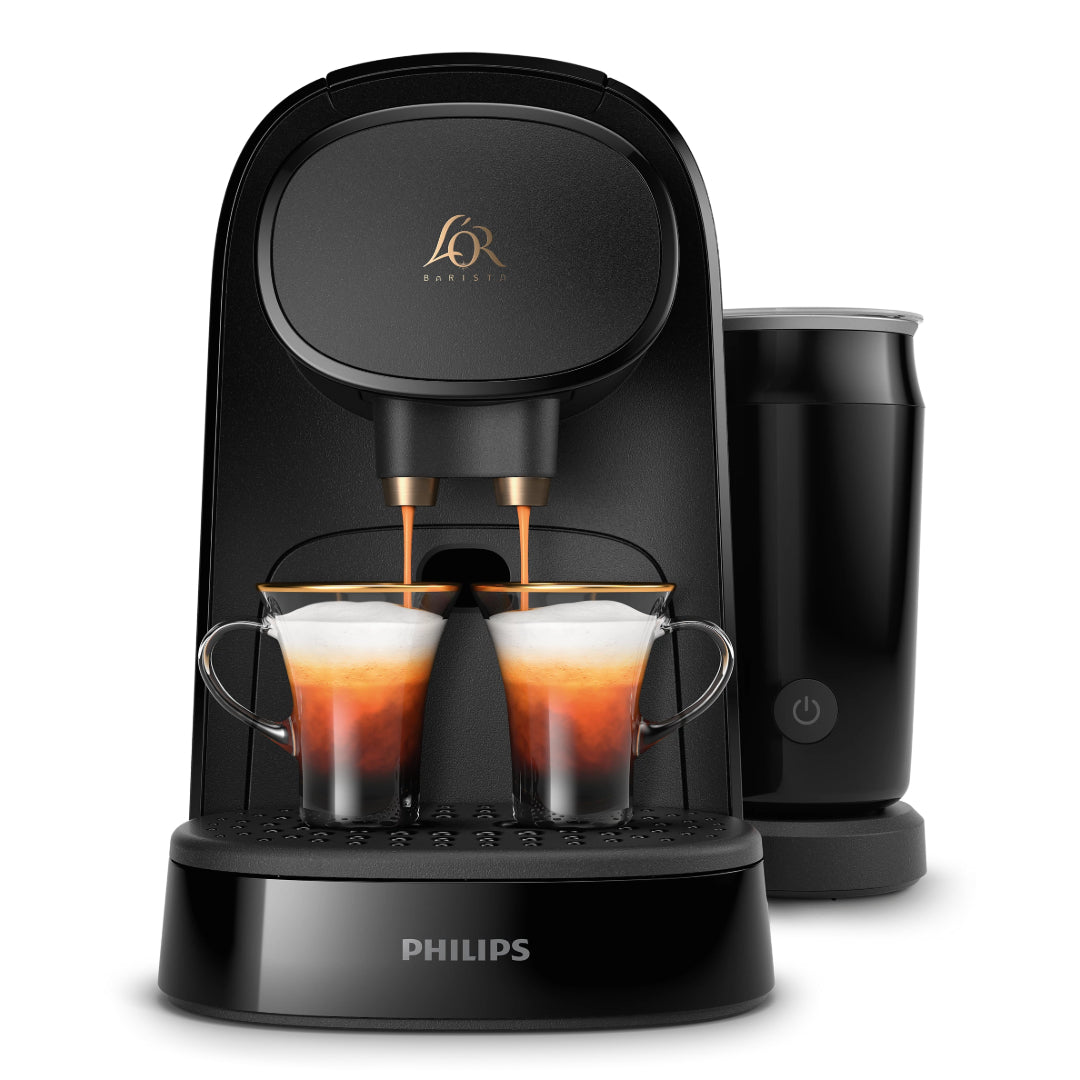 Philips L'OR Barista deep black capsule coffee machine with dual espresso cups filled with dark coffee, black milk frother on right side, gold accents and power button visible on front base