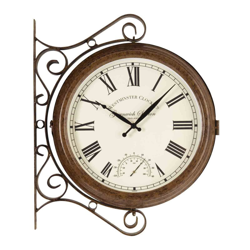 Vintage-style Westminster Clock with ornate scrolled metal bracket, 15-inch brown wooden frame, cream face with Roman numerals, black hands, and integrated thermometer dial, mounted wall clock in traditional station design