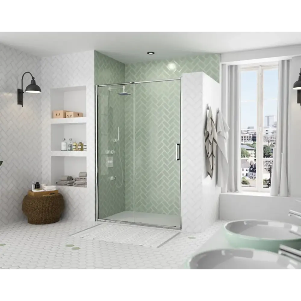 Merlyn ARYSTO Eight sliding shower door in chrome finish installed in modern bathroom with green herringbone tile surround, white subway tiles, and frosted glass enclosure